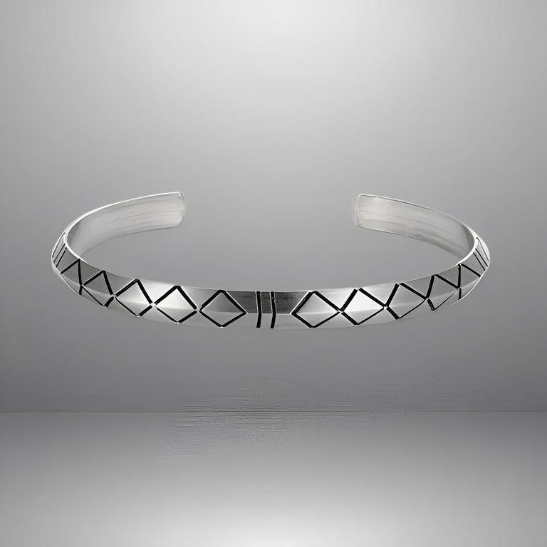 Product shot of a minimalist bangle bracelet made from durable aluminum alloy, featuring an adjustable clasp and unique geometric engraving, displayed against a plain background.